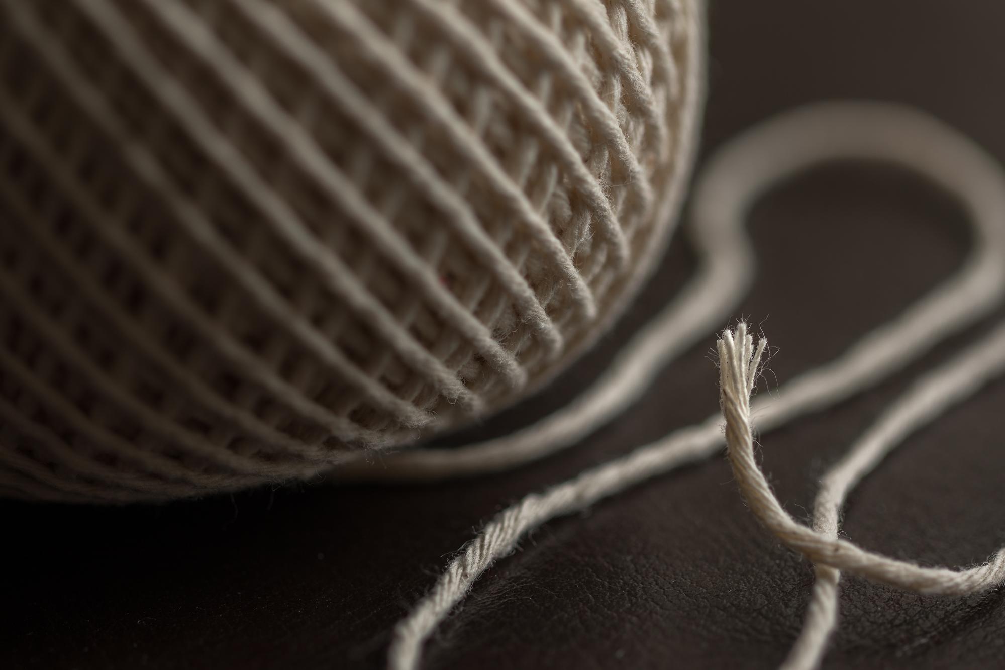 Close-up of hand embroidery on linen with earthy threads